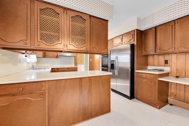 29947 Fernhill Dr, Farmington, MI 48331 - kitchen with stainless steel fridge, light countertops, a peninsula, and brown cabinets