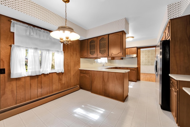 29947 Fernhill Dr, Farmington, MI 48331 - kitchen with a baseboard radiator, a peninsula, freestanding refrigerator, light countertops, and wallpapered walls