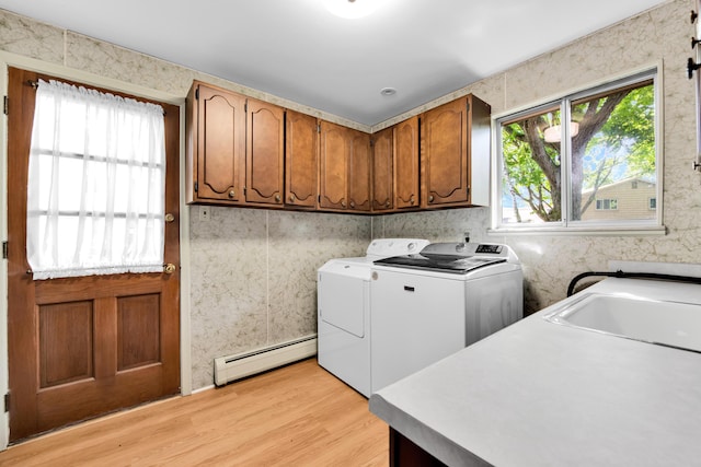 29947 Fernhill Dr, Farmington, MI 48331 - laundry area featuring baseboard heating, cabinet space, light wood-style flooring, and washing machine and dryer