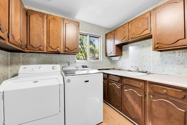 29947 Fernhill Dr, Farmington, MI 48331 - laundry room featuring separate washer and dryer, cabinet space, and light wood finished floors