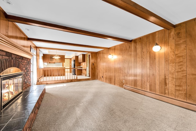 29947 Fernhill Dr, Farmington, MI 48331 - unfurnished living room with beam ceiling, a brick fireplace, wood walls, a baseboard heating unit, and carpet flooring