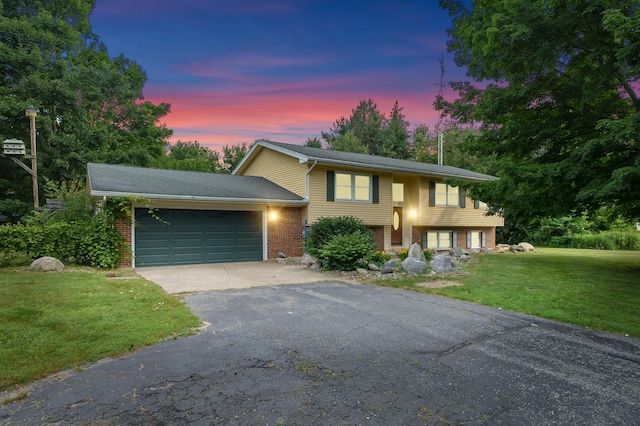34830 Riverview Dr, Paw Paw, MI 49079 - raised ranch with driveway, an attached garage, a yard, and brick siding