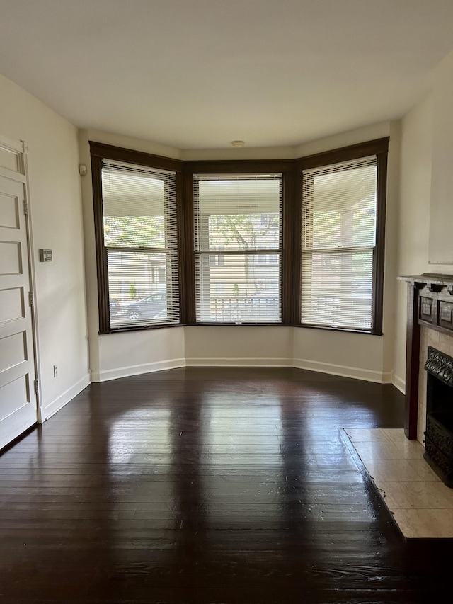 5208 Commonwealth St, Detroit, MI 48208 - unfurnished living room with a fireplace and hardwood / wood-style flooring