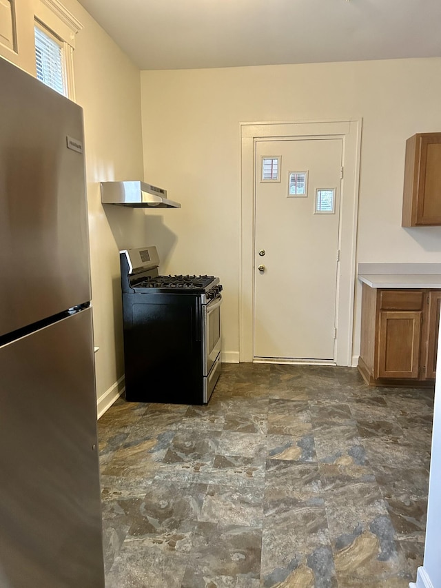 5208 Commonwealth St, Detroit, MI 48208 - kitchen with stainless steel appliances, ventilation hood, brown cabinets, and dark stone finish floors