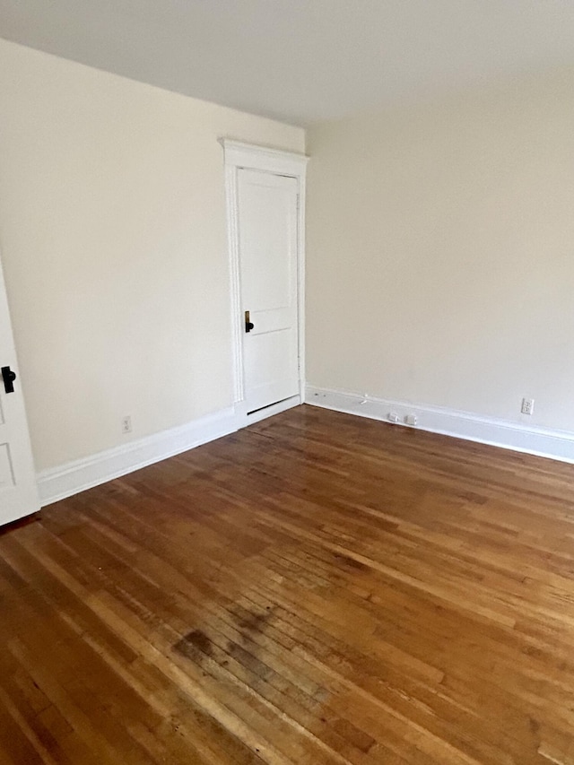 5208 Commonwealth St, Detroit, MI 48208 - spare room with dark wood-type flooring and baseboards