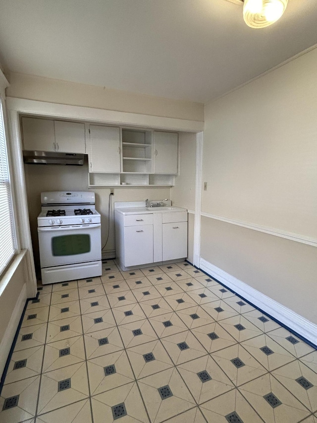 5208 Commonwealth St, Detroit, MI 48208 - kitchen featuring gas range gas stove, under cabinet range hood, open shelves, light countertops, and light tile patterned flooring