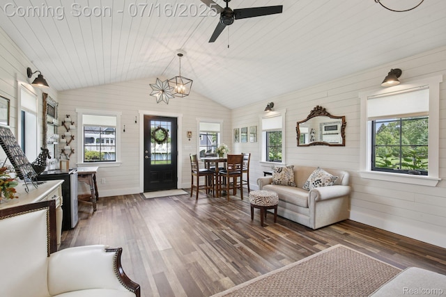 378 Fruitdale Ln, Pinckney, MI 48169 - living area featuring plenty of natural light, wood walls, wood finished floors, vaulted ceiling, and ceiling fan