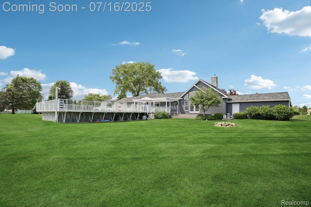 378 Fruitdale Ln, Pinckney, MI 48169 - back of property with a chimney, a yard, and an outdoor pool