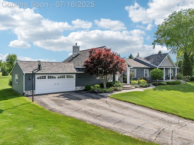 378 Fruitdale Ln, Pinckney, MI 48169 - view of front of house featuring an attached garage, driveway, a chimney, and a front lawn