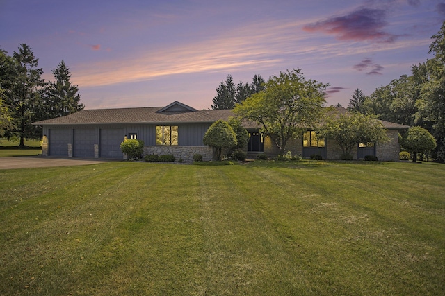 335 Fairway Dr, Coldwater, MI 49036 - view of front of house with a garage, stone siding, concrete driveway, and a front yard