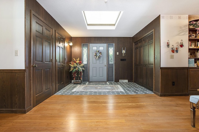 335 Fairway Dr, Coldwater, MI 49036 - foyer featuring light wood-type flooring, wood walls, and a wainscoted wall
