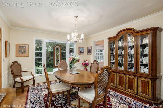 17 Colonial Rd, Grosse Pointe Shores, MI 48236 - dining room featuring a chandelier, light wood-style floors, and crown molding