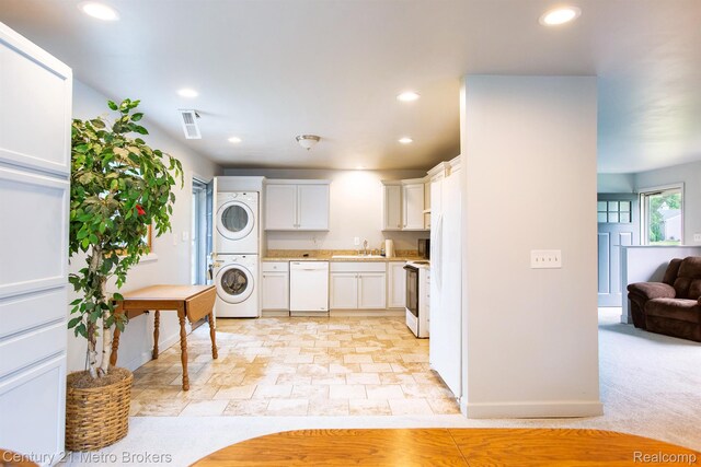 2512 Flintridge St, Lake Orion, MI 48359 - kitchen with estacked washer and dryer, white appliances, light countertops, recessed lighting, and white cabinetry