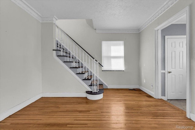 18040 Indiana St, Detroit, MI 48221 - foyer with ornamental molding, wood finished floors, stairs, and a textured ceiling