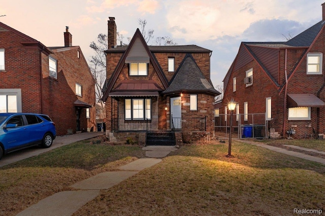18040 Indiana St, Detroit, MI 48221 - view of front facade with a chimney, stone siding, a gate, and a standing seam roof