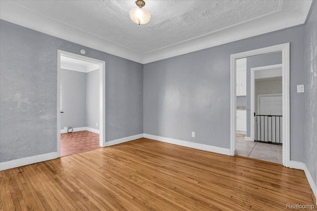 18040 Indiana St, Detroit, MI 48221 - spare room with light wood-type flooring and a textured ceiling