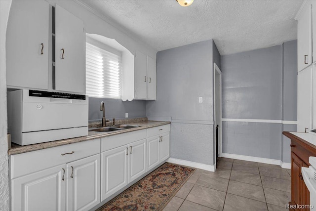 18040 Indiana St, Detroit, MI 48221 - kitchen with a textured ceiling, white cabinets, light countertops, and light tile patterned floors