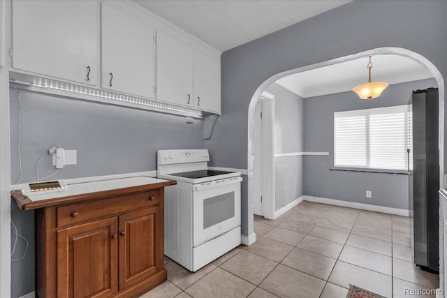 18040 Indiana St, Detroit, MI 48221 - kitchen featuring white electric range oven, arched walkways, light countertops, light tile patterned floors, and white cabinetry