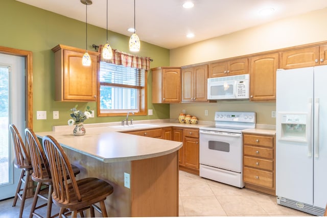 56234 Sink Rd, Dowagiac, MI 49047 - kitchen with white appliances, a peninsula, a kitchen bar, light countertops, and hanging light fixtures