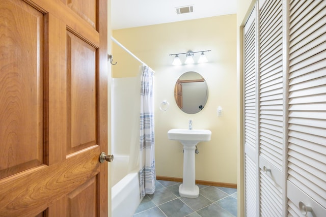 56234 Sink Rd, Dowagiac, MI 49047 - bathroom featuring a closet, shower / tub combo with curtain, and tile patterned flooring