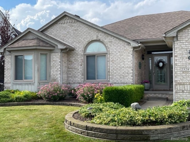 23287 Angel Park Dr, Macomb, MI 48042 - view of front of house with brick siding, a front lawn, and roof with shingles