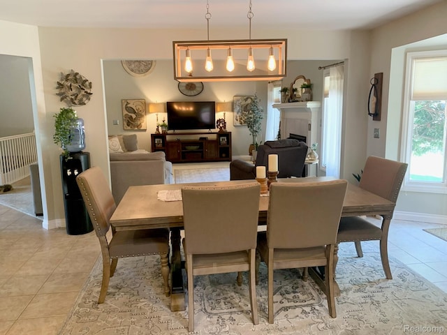 23287 Angel Park Dr, Macomb, MI 48042 - dining space featuring light tile patterned floors and a tiled fireplace