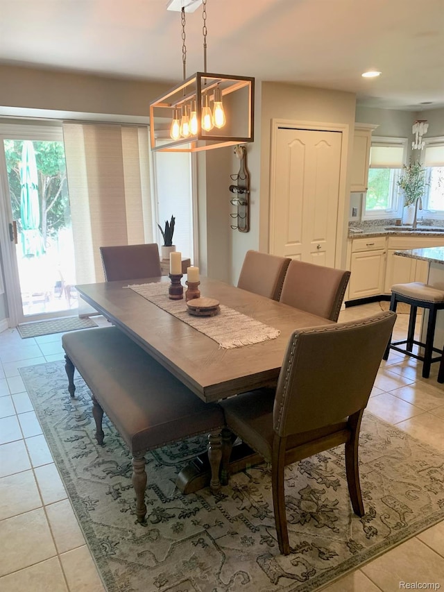 23287 Angel Park Dr, Macomb, MI 48042 - dining space featuring light tile patterned floors and a chandelier