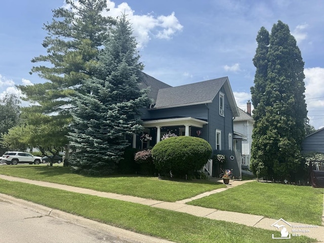 402 W Sixth St, Monroe, MI 48161 - view of front of home featuring a front yard and a chimney