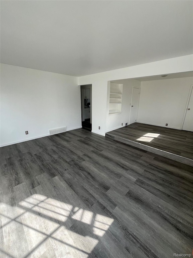 7800 Rutland St, Detroit, MI 48228 - unfurnished living room with dark wood-style flooring