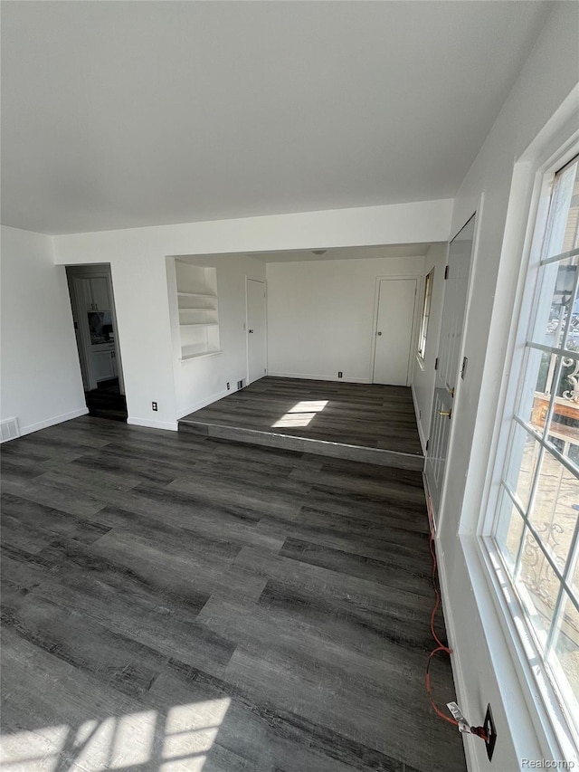 7800 Rutland St, Detroit, MI 48228 - unfurnished living room featuring dark wood finished floors and baseboards