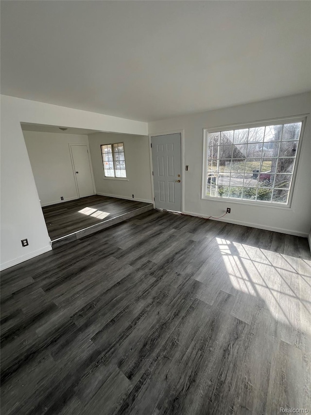 7800 Rutland St, Detroit, MI 48228 - unfurnished living room featuring dark wood-type flooring and baseboards