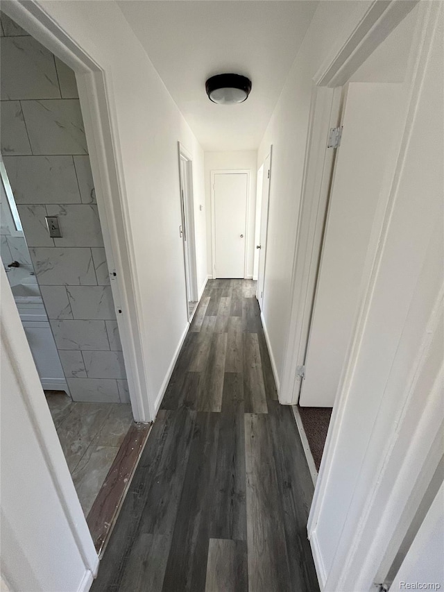 7800 Rutland St, Detroit, MI 48228 - hallway featuring dark wood-style floors and baseboards