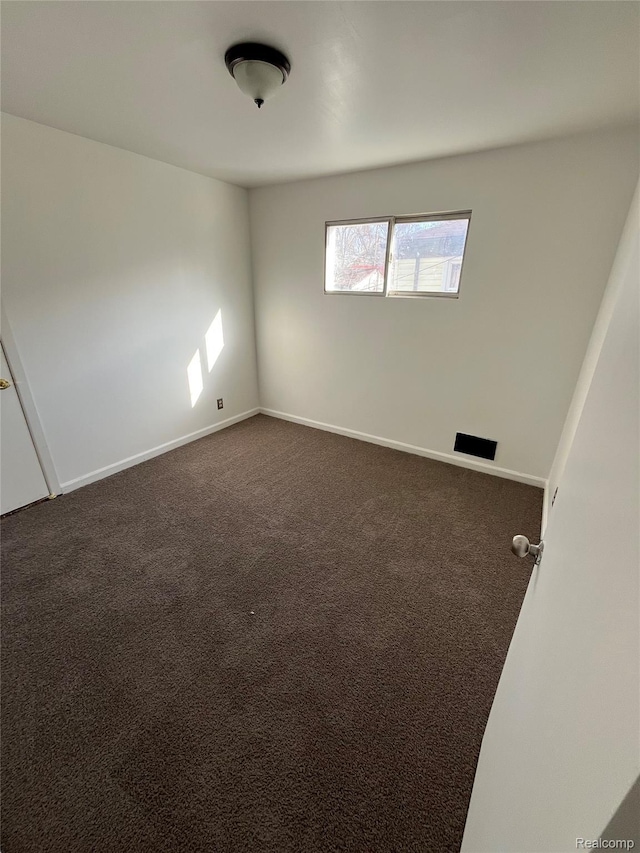 7800 Rutland St, Detroit, MI 48228 - empty room with dark colored carpet and baseboards