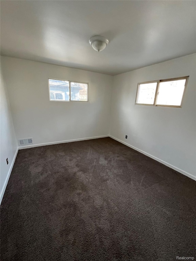 7800 Rutland St, Detroit, MI 48228 - spare room with dark carpet and baseboards