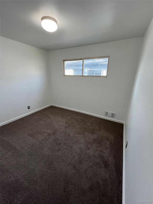 7800 Rutland St, Detroit, MI 48228 - empty room featuring baseboards and dark carpet