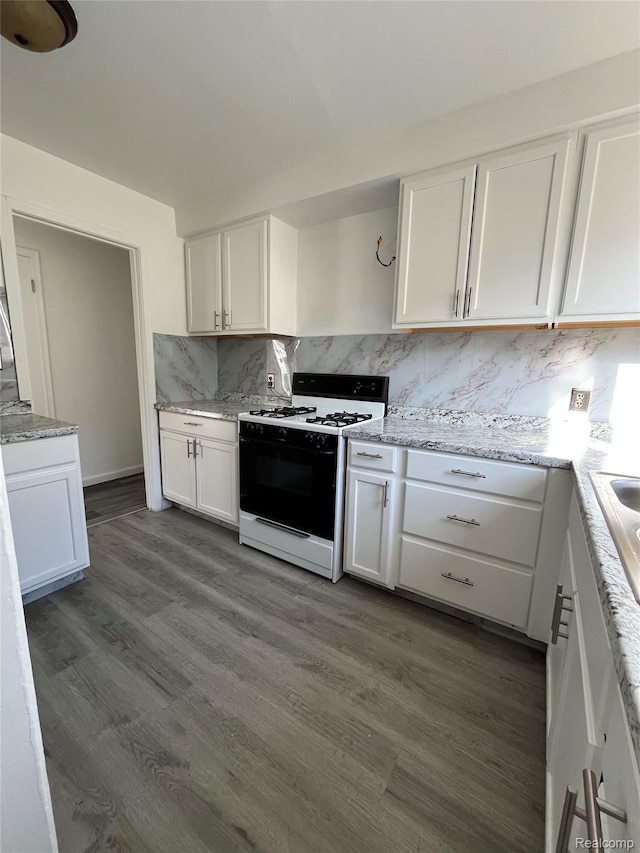 7800 Rutland St, Detroit, MI 48228 - kitchen with gas range oven, white cabinets, tasteful backsplash, and dark wood-type flooring