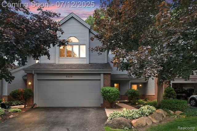 6559 Ridgeview Dr, Clarkston, MI 48346 - view of front of house with a garage, brick siding, driveway, and a shingled roof
