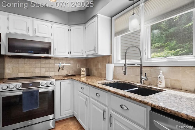6559 Ridgeview Dr, Clarkston, MI 48346 - kitchen featuring stainless steel appliances, light stone countertops, white cabinetry, and healthy amount of natural light