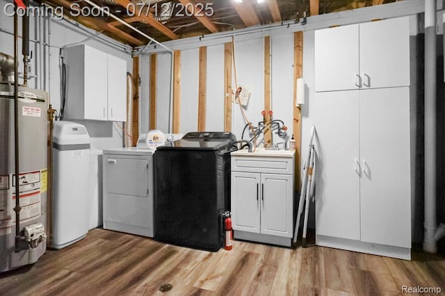 6559 Ridgeview Dr, Clarkston, MI 48346 - washroom with independent washer and dryer, water heater, cabinet space, and light wood finished floors