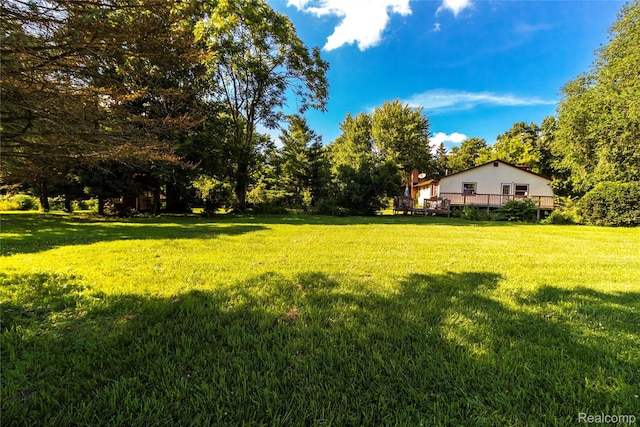 2380 Wilder Rd, Metamora, MI 48455 - view of green lawn featuring a wooden deck