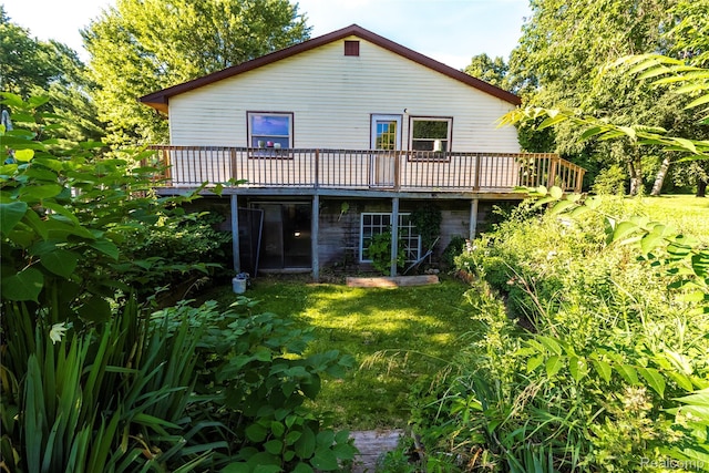 2380 Wilder Rd, Metamora, MI 48455 - rear view of house with a wooden deck and a yard