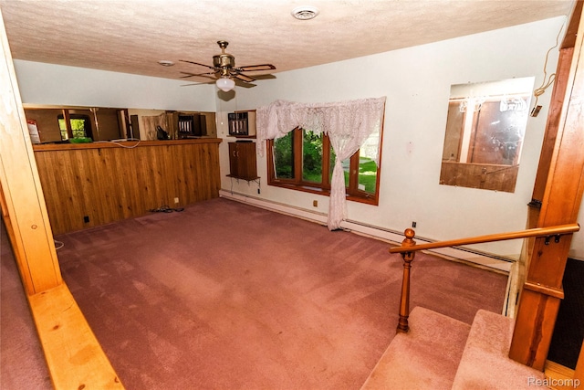 2380 Wilder Rd, Metamora, MI 48455 - unfurnished living room with a textured ceiling, carpet, ceiling fan, and baseboard heating