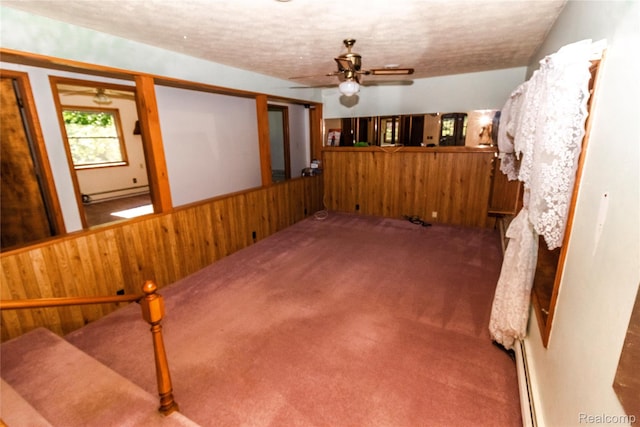 2380 Wilder Rd, Metamora, MI 48455 - below grade area with ceiling fan, carpet floors, wood walls, baseboard heating, and a wainscoted wall