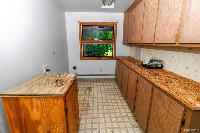 2380 Wilder Rd, Metamora, MI 48455 - laundry room with cabinet space, electric dryer hookup, light floors, washer hookup, and a baseboard heating unit