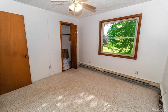2380 Wilder Rd, Metamora, MI 48455 - unfurnished bedroom with baseboard heating, carpet floors, and ceiling fan
