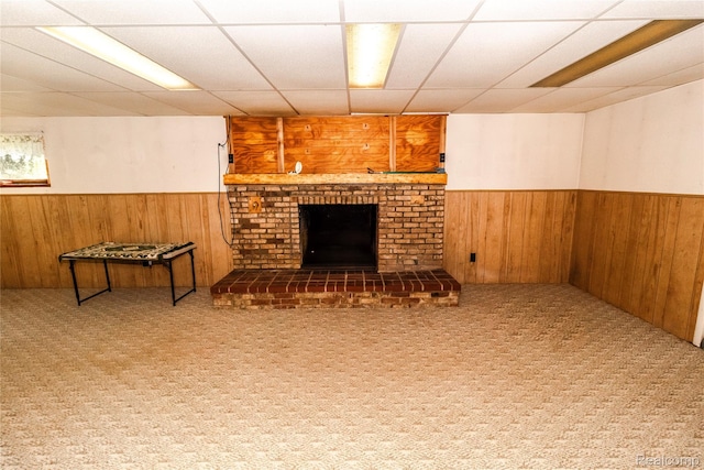 2380 Wilder Rd, Metamora, MI 48455 - finished below grade area with wainscoting, wooden walls, a paneled ceiling, a brick fireplace, and carpet
