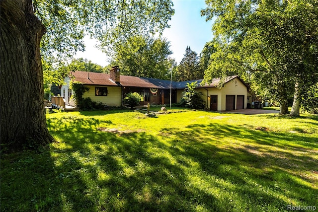 2380 Wilder Rd, Metamora, MI 48455 - view of grassy yard with a garage and driveway