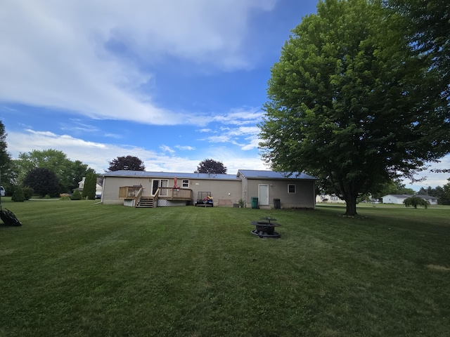 274 Pioneer St, Mendon, MI 49072 - rear view of house featuring a lawn, a deck, and a fire pit