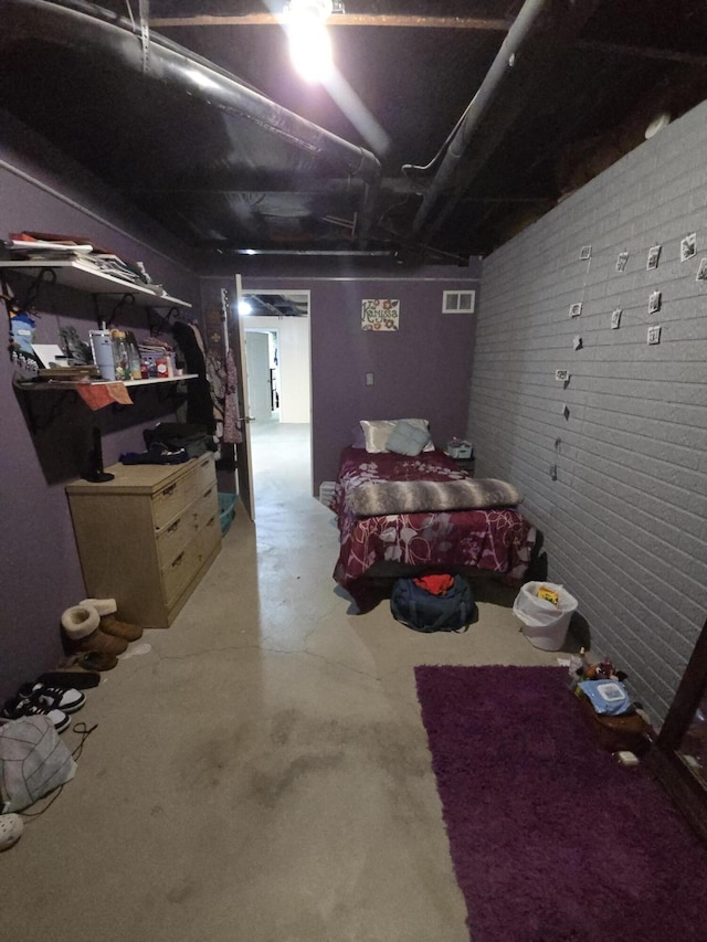 274 Pioneer St, Mendon, MI 49072 - bedroom featuring brick wall and concrete floors