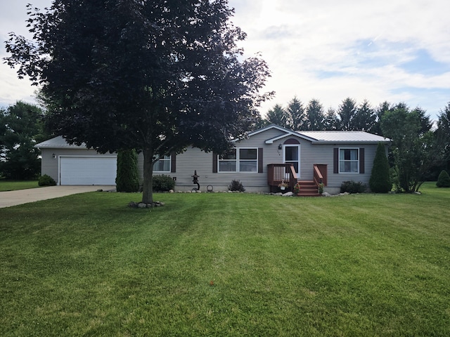 274 Pioneer St, Mendon, MI 49072 - view of front of house featuring a garage, driveway, a front lawn, and a metal roof